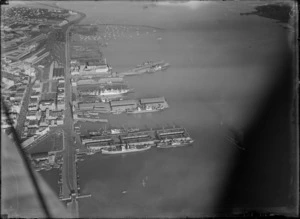 Auckland City waterfront, showing the Empress of Britain steam passenger ship docked at the wharf, with an unidentified ship alongside it on the right