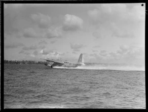 View of the TEAL Short Tasman flying boat ZK-AMD 'Australia' taking off, Auckland