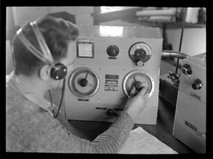 R D Goodman, listening to transmissions through headphones, Musick Point Air Radio Station, Howick, Auckland