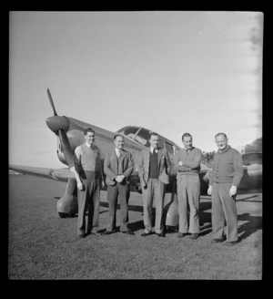 Group of men at Mangere, Auckland, on assembly of first Percival Proctor ZK-AJY aircraft, in post war period in New Zealand
