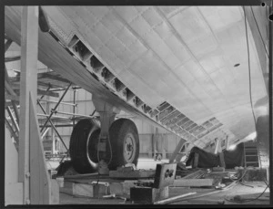 View under wing of a Short Tasman aircraft, in a workshop, Hobsonville, Auckland