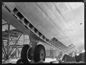 View under wing of a Short Tasman aircraft, inside a workshop, Hobsonville, Auckland