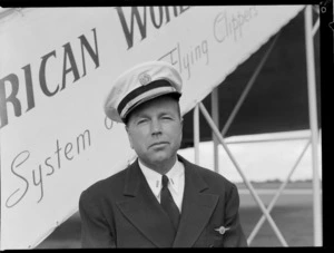 Portrait of Captain J H Kelly, Pan American Airways pilot, in front of a PAA Clipper Class Aeroplane, Whenuapai Airfield, Auckland