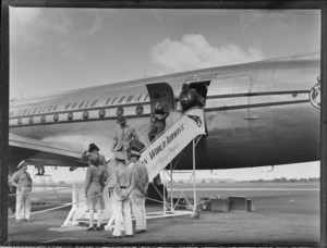 Unidentified passengers disembarking Pan American World Airways (PAWA) clipper aircraft 'Malay' at Whenuapai Airbase, Auckland