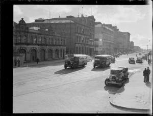 Wakefield Oil Company, with a view of Quay Street and the United Repairing Co Ltd building, motorcars and two Key's Buses, Auckland City