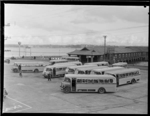 Wakefield Oil Company, with a view of Devonport Wharf and the North Shore Transport Co Ltd bus station with passengers boarding, Auckland City
