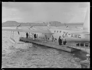 Passengers, including two nuns, disembarking from Tasman Empire Airways Short S25 Sandringham 4 flying boat ZK-AME 'New Zealand', at Mechanics Bay, Auckland