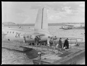 Passengers disembarking Tasman Empire Airways Short S25 Sandringham 4 flying boat ZK-AME 'New Zealand', at Mechanics Bay, Auckland