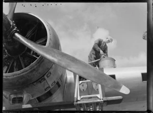 An unidentified mechanic refuelling an aeroplane, at Mechanics Bay, Auckland