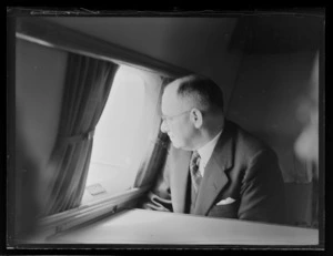 John C Allum, Mayor of Auckland, looking out of the window of an aeroplane