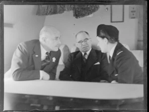 Sir Patrick Duff, left, with Mayor of Auckland John C Allum, and Miss Woolley, [a stewardess?], aboard an aeroplane