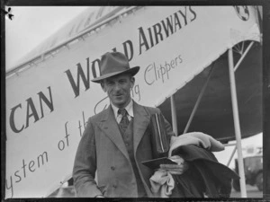 Portrait of Berridge Spencer in front of a Pan American Airways Clipper Class passenger plane boarding ramp, Whenuapai Airfield, Auckland