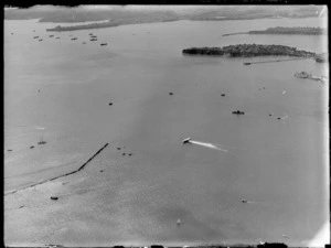 View of the Imperial Airways Flying Boat 'Centaurus' landing on Auckland Harbour with Stanley Bay and Devonport Naval Base beyond