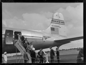 View of unidentified passengers disembarking Pan American Airways NC-88888 Clipper Class 'East India' passenger plane, Whenuapai Airfield, Auckland