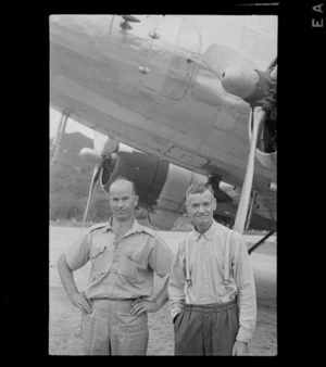 Portrait of J L Scott of Aerodrome Services (left) and an unidentified man in front of a twin engine transport plane, Rarotonga, Cook Islands