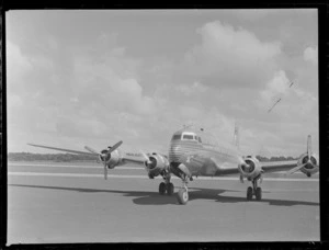 View of PAA NC-69883 Clipper Class Kathay four engine passenger plane taxiing on runway, Whenuapai Airfield, Auckland