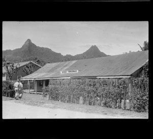 View of the Bonar and Shearman store front with two unidentified men, Rarotonga, Cook Islands