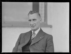 Portrait of H M Mackay of TEA in front of an unknown building, [Mechanics Bay, Auckland?]