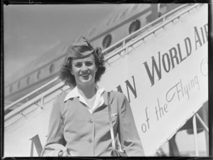 Stewardess Mary Lyman for PAWA (Pan American World Airways), in front of PAWA aircraft passenger stairs