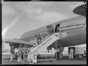 Passengers disembarking aircraft PAWA (Pan American World Airways) Clipper Kit Carson, including staff crew on tarmac