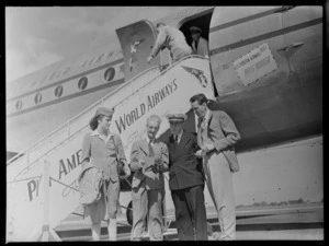 Mary Lyman (Stewardess), Mr M Grindle (Port Steward), Captain C V George and Mr Q Campbell (Airport Manager) standing next to aircraft PAWA (Pan American World Airways) Clipper Kit Carson
