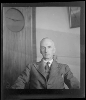 Portrait of [G Bolt?], Chief Engineer for TEA (Tasman Empire Airways), in an unknown office