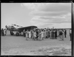Opening of Northland Air Service, Kaikohe, showing crowds of people around an aircraft