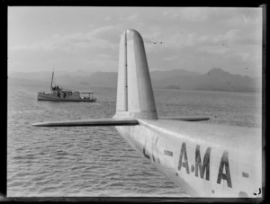 View of harbour, Suva, Fiji, including tail of Tasman Empire Airways Ltd Short Empire flying boat 'Aotearoa' ZK-AMA, and an unidentified boat