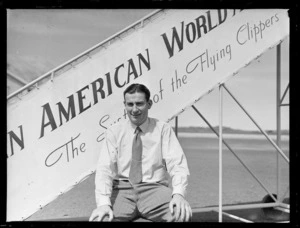 Portrait of Pan American Airways passenger Thomas Clark in front of PAA plane boarding steps, Whenuapai Airfield, Auckland