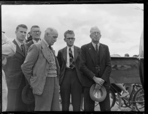 Group official's portrait with (R to L) J B Taaffe, RH Williams, F Holden and J F Johnston, in front of NAC mail plane 'Kahu' for the opening ceremony of the Northland Air Service at Onerahi Airport, Whangarei, Northland
