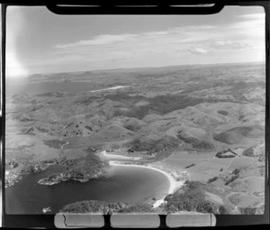 View to Matapouri Bay with sandy beach and settlement to hilly farmland beyond, looking south to Ngunguru Bay, Northland Region