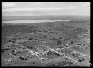 View of the settlement of Kaikohe, Northland region, surrounded by farmland, with Lake Omapere behind