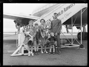 Professor Ernest Beaglehole and family, standing next to Pan American World Airways clipper