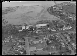 View of W Sutherland & Co Ltd Tannery and NZWMA Scourers Ltd buildings with Manukau Harbour tidal flats beyond, Onehunga, South Auckland