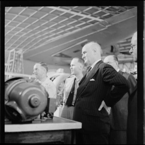 Mr L Turnhill (left) and BR GEN (Brigadier General) Alfred Cecil Critchley (right), including three other unidentified men, viewing aircraft machinery, RNZAF (Royal New Zealand Air Force)