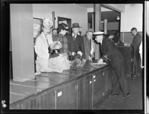 Passengers and customs officials, in customs area of Tasman Empire Airways Ltd, Auckland