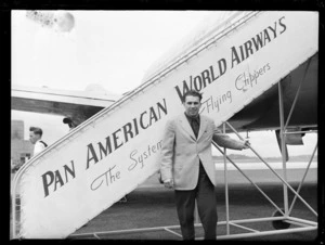 Mr Tony Pastor, champion boxer from America, standing next to PAWA (Pan American World Airways) clipper