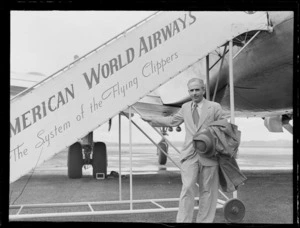 Portrait of Mr Juan Lemon of Pan American Airways in front of PAA plane boarding steps, Whenuapai Airfield, Auckland