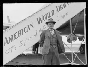 Portrait of Mr Wallace Clarke of Pan American Airways in front of PAA plane boarding steps, Whenuapai Airfield, Auckland