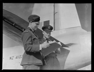 Portrait of S/L Tillson OBE and Flight Lieutenant Patterson MBE in front of a RNZAF plane, Whenuapai Airfield, Auckland