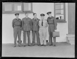 Portrait of RNZAF Sunderland Flying Boat flight personnel in front of a building (L to R) S/L H P B Dive, F/L S Wilson, F/L D A Patterson, S/L G A Tillson and S/L R J R H Makgill, Mechanics Bay, Auckland City