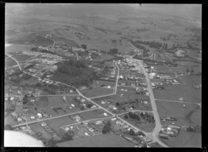 The town of Kaitaia with North Road in foreground into Commerce Street through town and Memorial Park covered in bush on the right, looking south to farmland beyond, Northland Region
