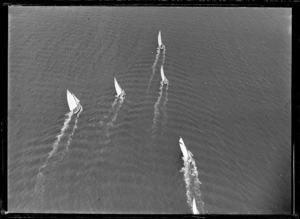 View of a yacht race including a [Gaff cutter?] class yacht along the coast, [Auckland Region?]