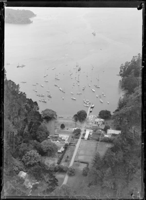 Looking down on Governor Grey's residence with tennis courts and gardens and Mansion House Bay with jetty and yachts moored in cove, Kawau Island, Auckland Region
