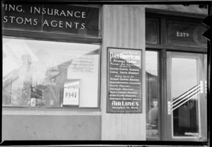 Exterior of Henderson & Macfarlane Ltd, travel agents, showing window display, [Auckland?]