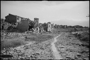 Rubble littered road is main thoroughfare from Orsonga to Ortona, Italy, - Photograph taken by G Kaye