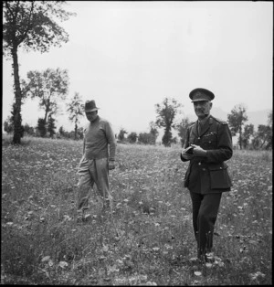 Prime Minister Peter Fraser and Lieutenant General Edward Puttick walk through poppy field in Cassino area, Italy - Photograph taken by M D Elias