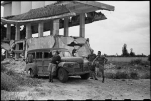 Captain E G Webber, G Archer and S Greenwood alongside a demolished building near Foggia, Italy, World War II - Photograph taken by George Bull