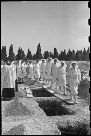 Sisters filing past grave of Sister A S Crampton who died from an accident at 3 NZ General Hospital, Italy, World War II - Photograph taken by George Bull