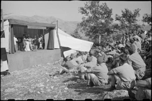 NZ Division personnel watching Kiwi Concert Party performance for Prime Minister Peter Fraser, Italy, World War II - Photograph taken by George Bull